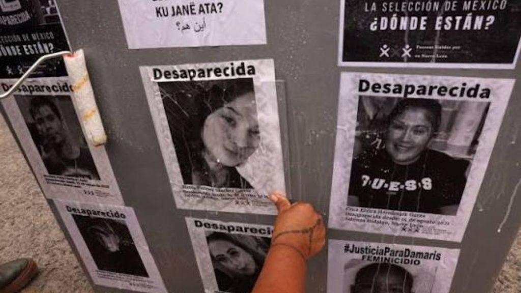 Nuevo-leon-top-5-desaparecidos - Justicia Regia Wall with Missing-person Flyers Reading 'desaparecida'; a Hand Points to One Photo Among Several Notices - Justicia Regia