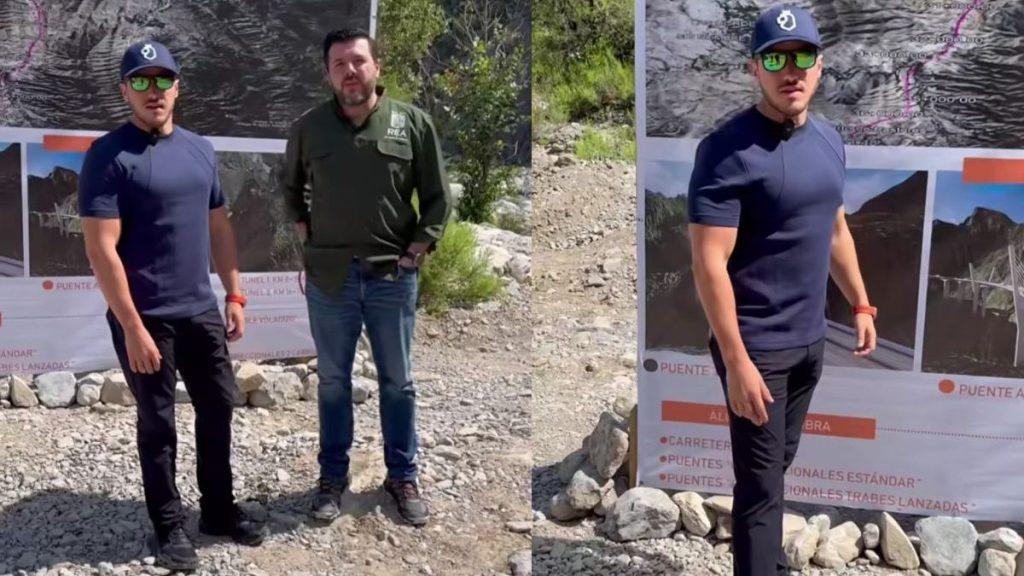 Tramo-3-de-carretera-interserrana - Justicia Regia Two Men Stand on a Rocky Outdoor Site Beside a Large Map Banner; One Wears a Navy Shirt, Cap, and Sunglasses, the Other a Green Shirt. - Justicia Regia