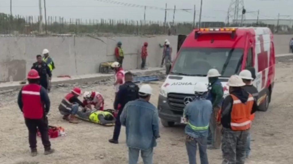 Emergency Responders Provide First Aid to an Injured Person on a Gravel Road As a Red-and-white Ambulance Waits Nearby. - Justicia Regia